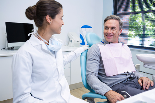 Dentist explaining the mouth and body connection to a patient at Martin Periodontics in Mason & North Cincinnati, OH