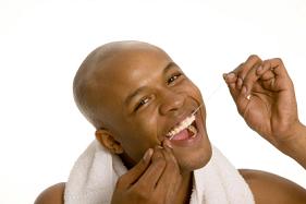 Image of a man flossing, at Martin Periodontics in Mason, OH.