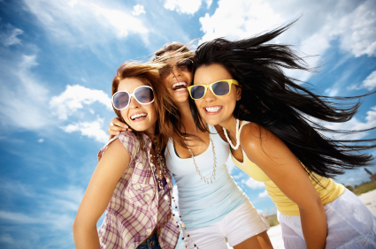 Three women smiling after receiving cosmetic dentistry treatments at Martin Periodontics in Mason & North Cincinnati, OH